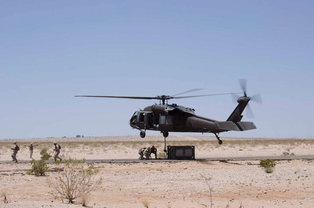 Marines hook a fuel tank to a UH-60 Black Hawk helicopter - NARA ...