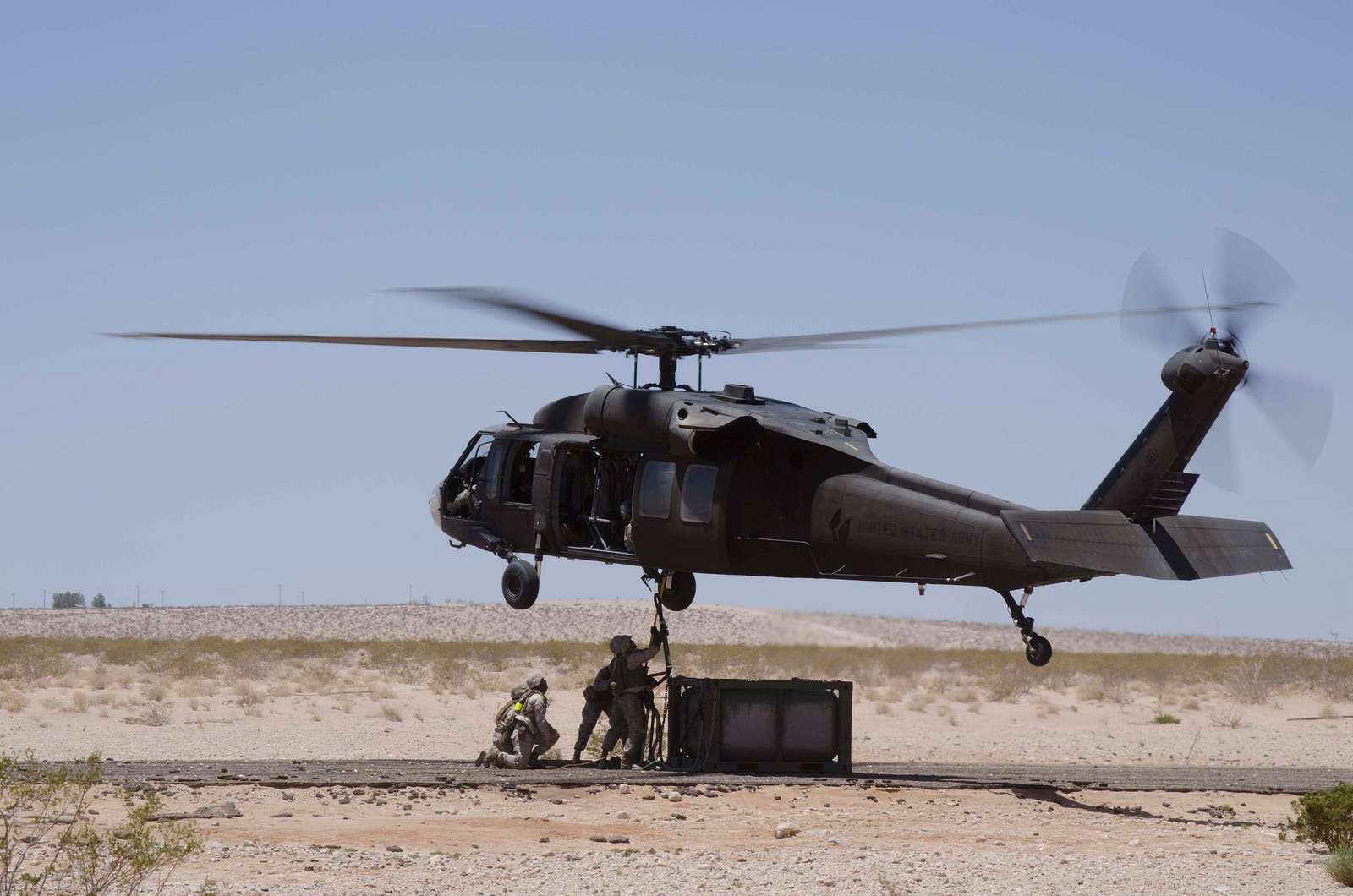 Marines hook a fuel tank to a UH-60 Black Hawk helicopter - NARA ...