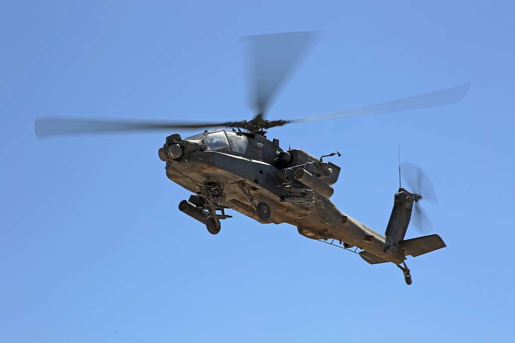 An U.s. Army Ah-64 Apache Helicopter Passes Over Soldiers - Picryl 