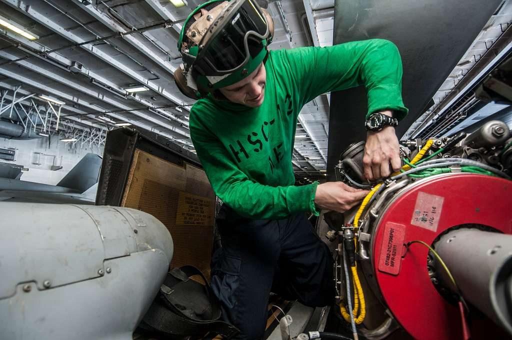 Offensive Tackle for the National Football League (NFL) San Diego Chargers,  Leander Jordan (75), signs an autograph for Aviation Electrician's Mate 3rd  Class Jerimy Holt during a visit aboard USS Ronald Reagan (