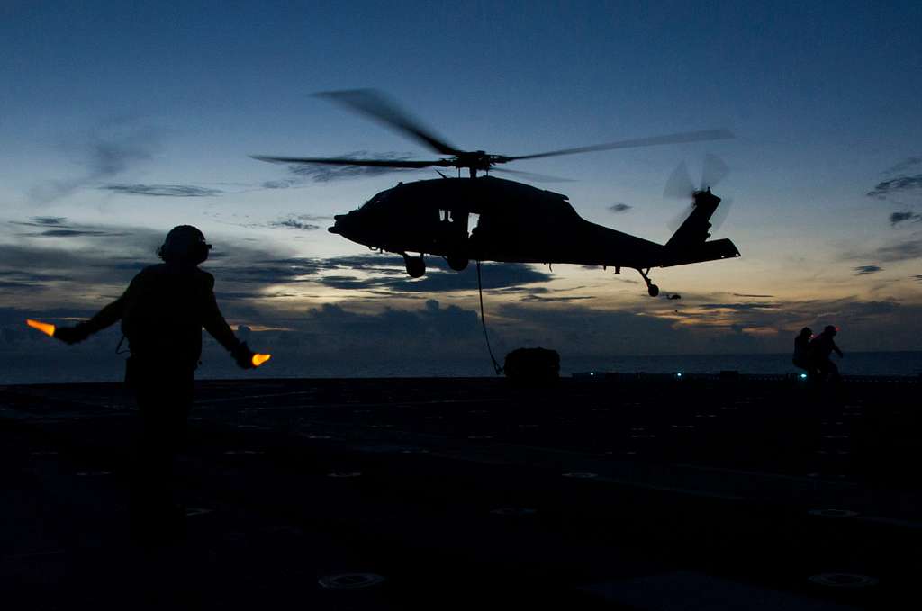 An aviation boatswain’s mate (handling) directs an - NARA & DVIDS ...