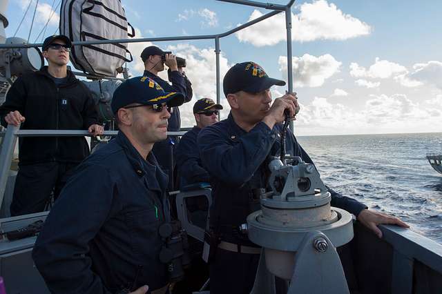 Lt. Cmdr. Robert Kallman orders a course change while - NARA & DVIDS ...