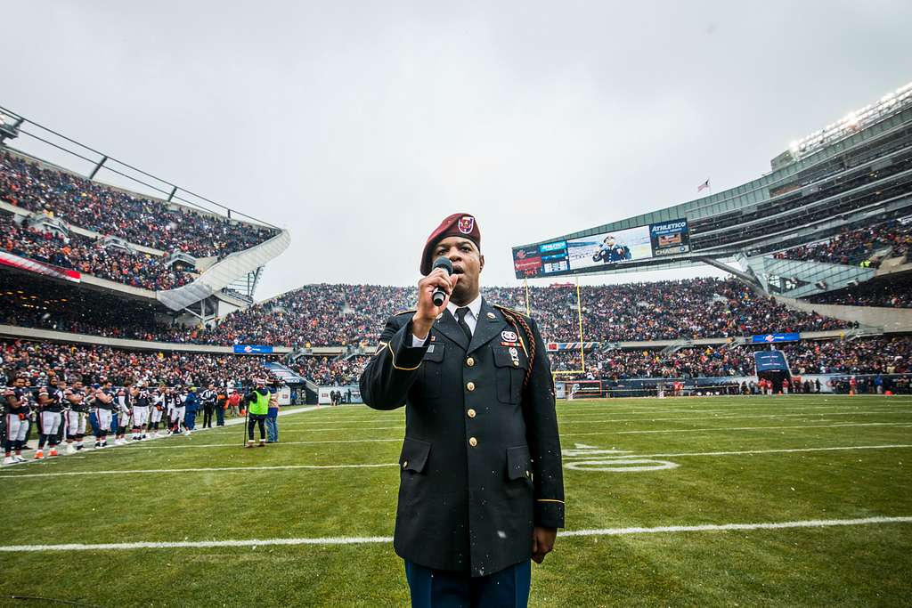 Service members take photos with Staley Da Bear, the Chicago Bears mascot  during the Chicago Bears Salute to Service game Nov. 27 at Soldier Field,  in Chicago. Nearly 100 personnel from all