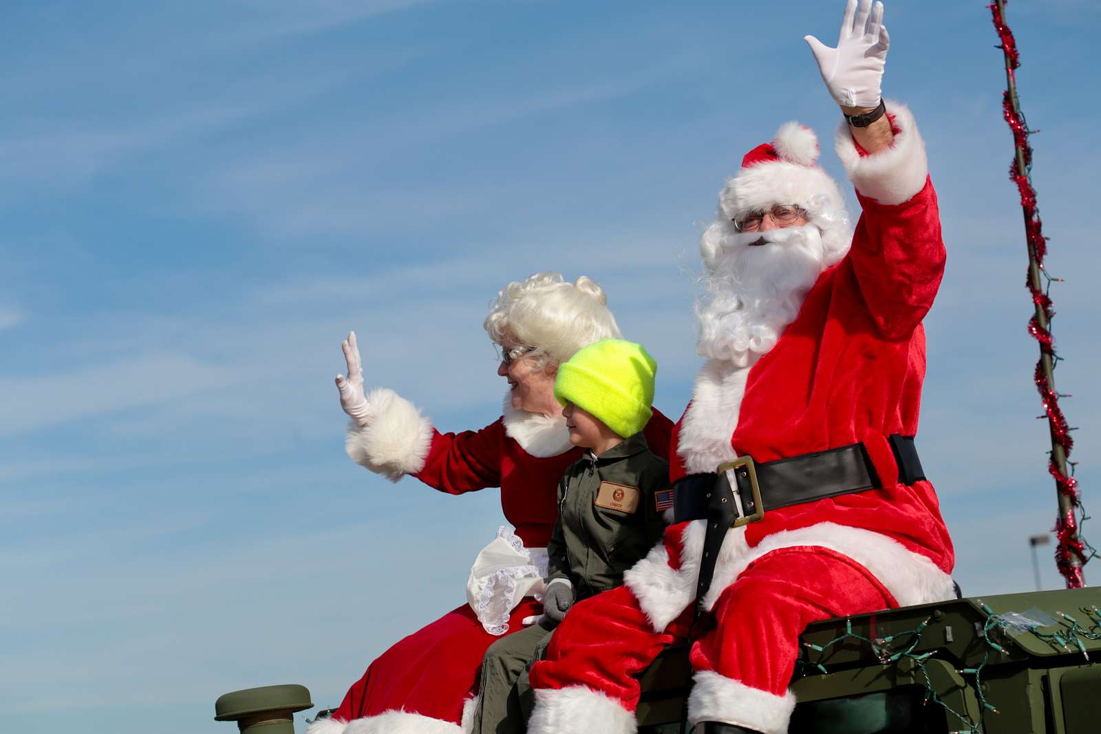 Santa Claus, Mrs. Claus, And An Elf Wave As They Ride - Nara & Dvids 