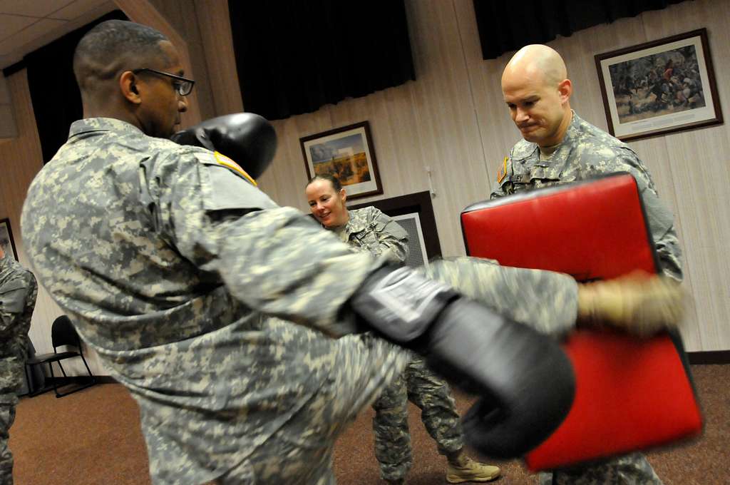 U.S. Army Sgt. 1st Class Joe Baker demonstrates a choke hold on Officer  Candidate Wendy McDougall during combatives training at the Bethany Beach  Training Site in Bethany Beach, Del., June 7, 2015.