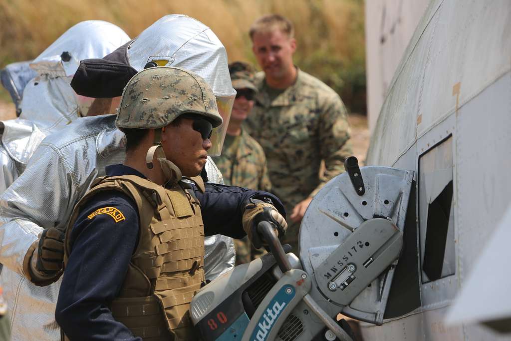 A Royal Thai Navy firefighter cuts an emergency evacuation - PICRYL ...