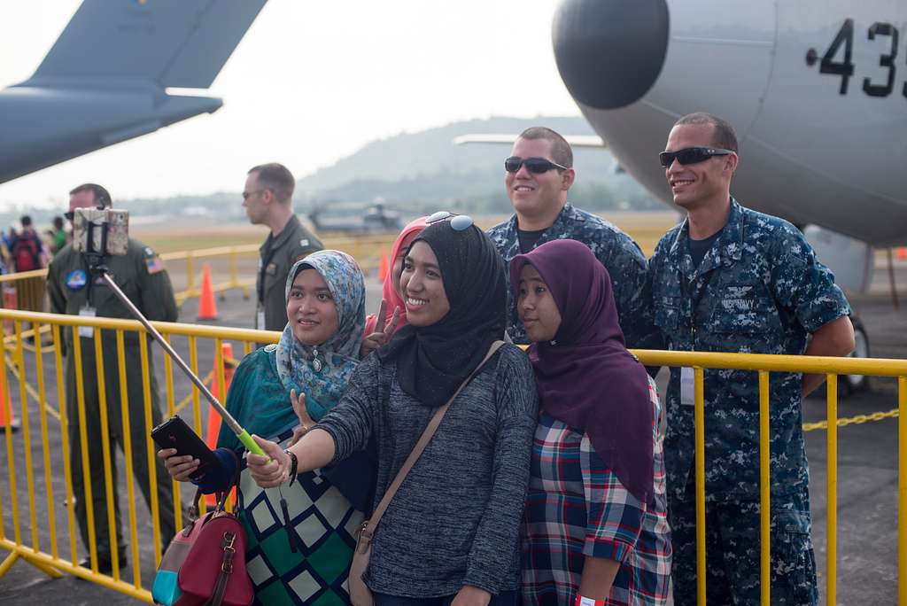 U.S. Navy Sailors pose for a selfie with audience members - PICRYL