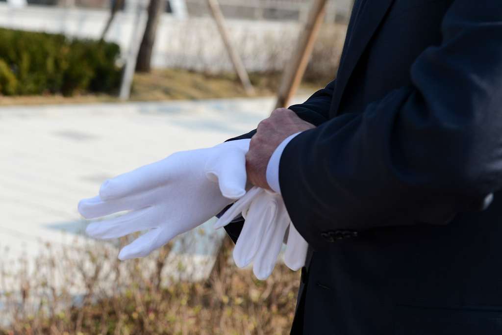 Secretary of Defense Ash Carter steadies his hand using the