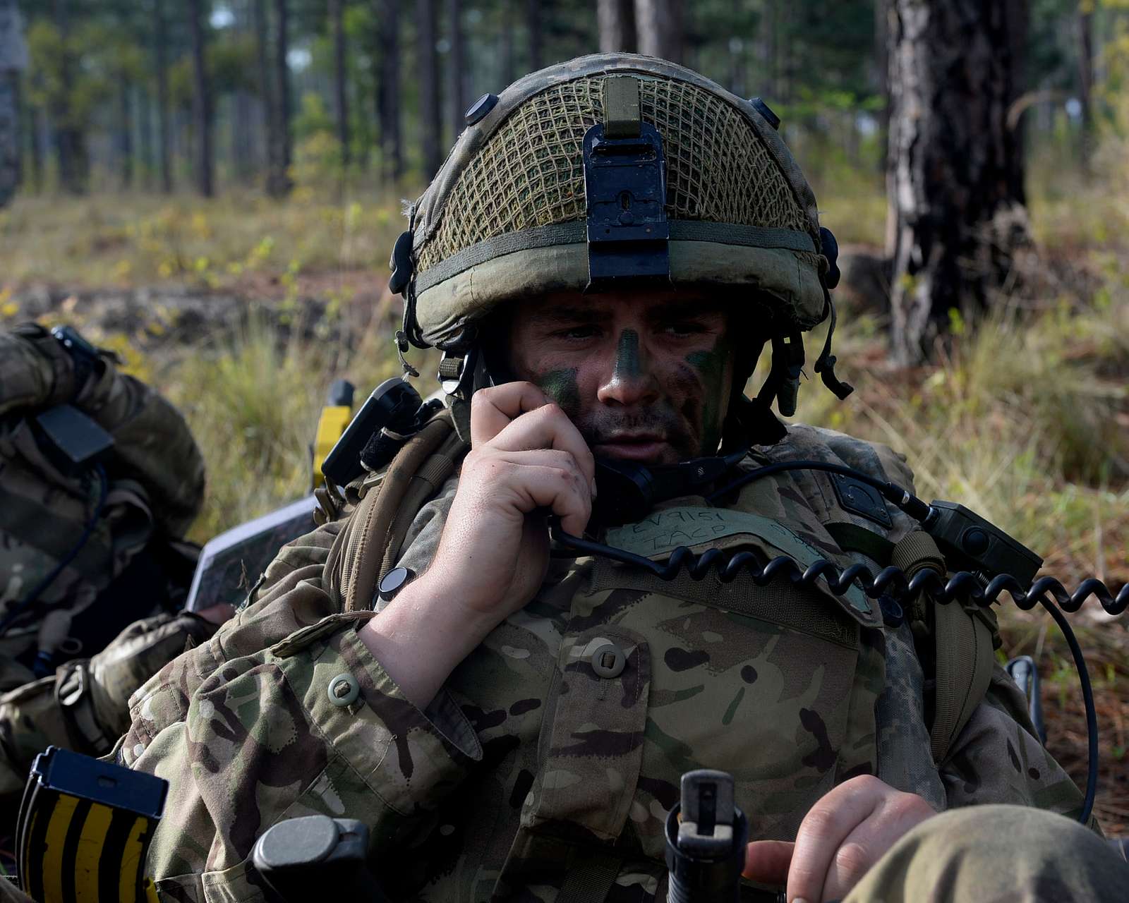 A U.K. Army paratrooper checks his radio communication - NARA & DVIDS ...