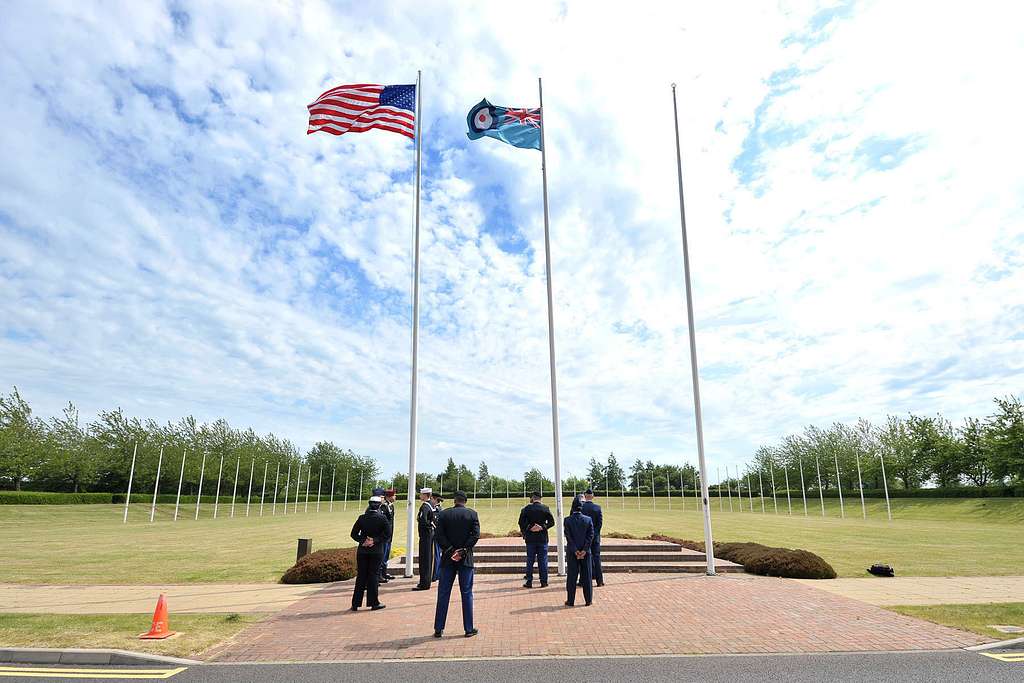 U.S. service members with the RAF Molesworth Honor Guard uncase the colors  of the American flag before the start of the International Series, Miami  Dolphins versus New York Jets NFL game at