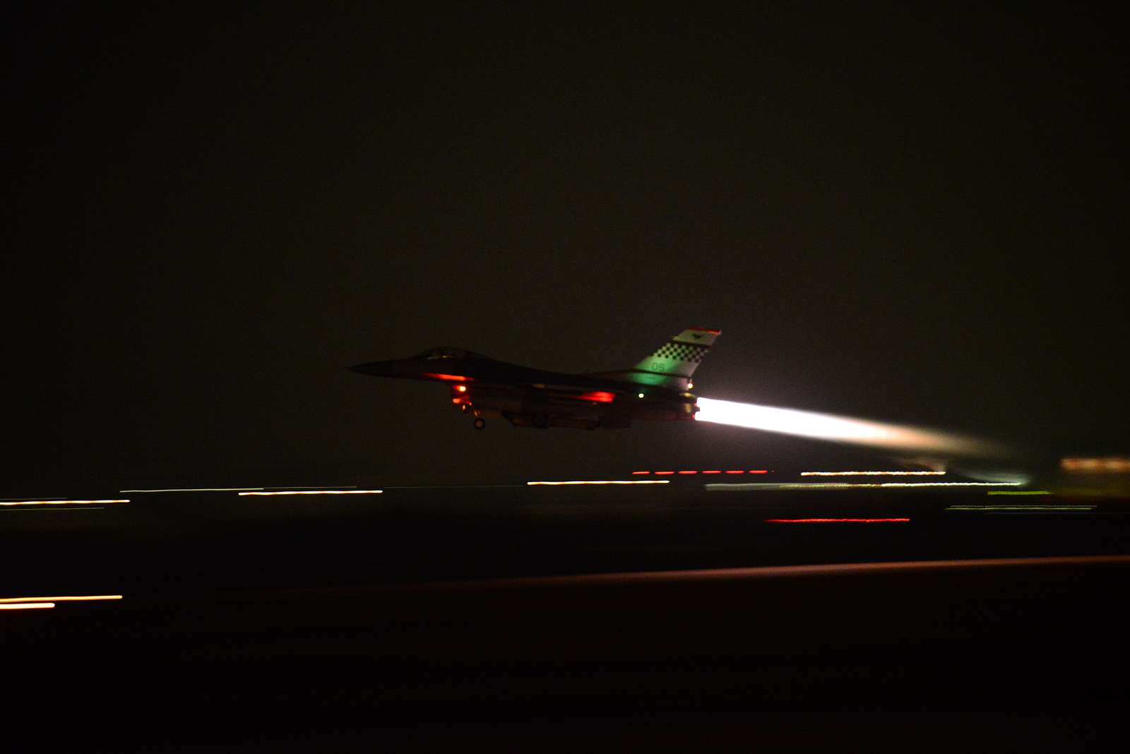 An F-16 Fighting Falcon screams down the runway spiting - NARA & DVIDS ...