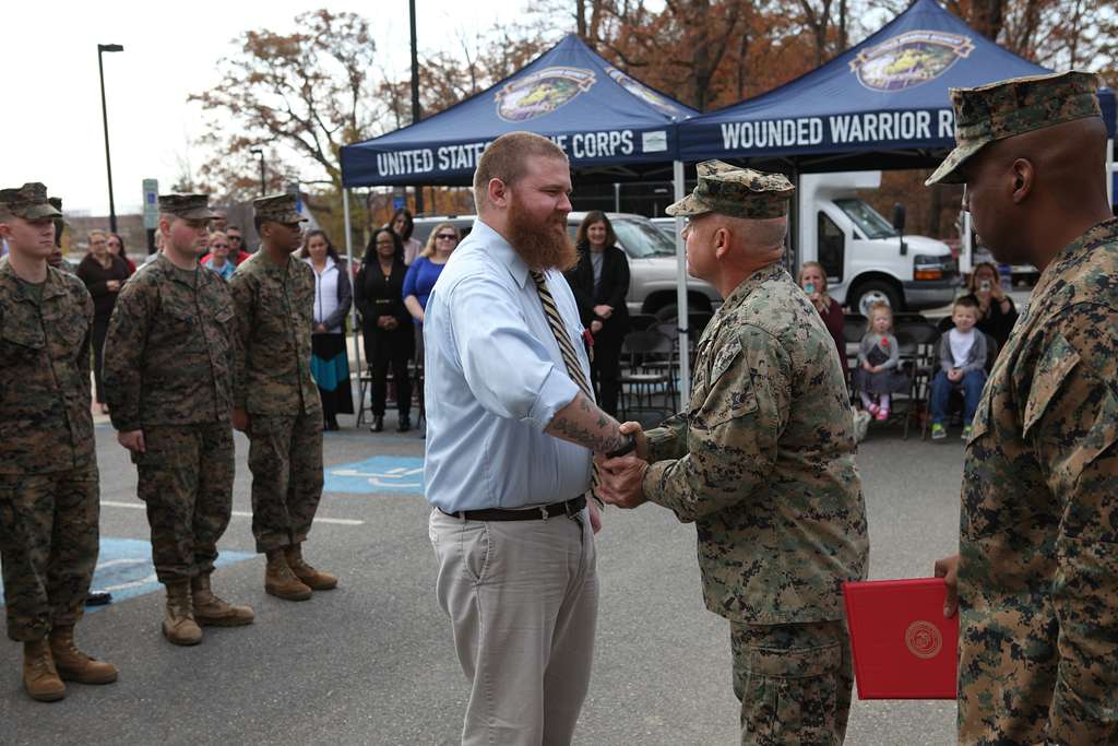 US Marine Corps Col. Willard Buhl congratulates retired PICRYL