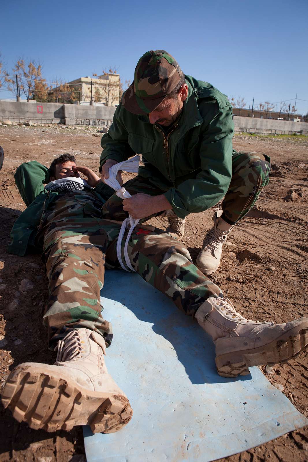 A Peshmerga soldier applies a make-shift tourniquet - NARA & DVIDS ...