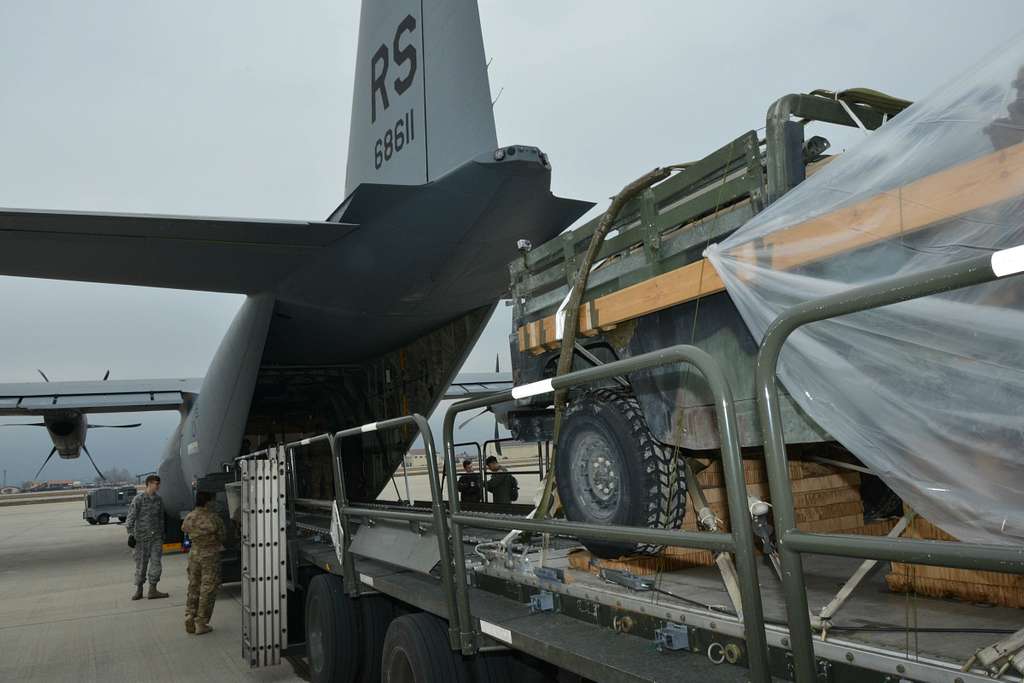 U.S. service members load a parachute-rigged Humvee, - NARA & DVIDS ...