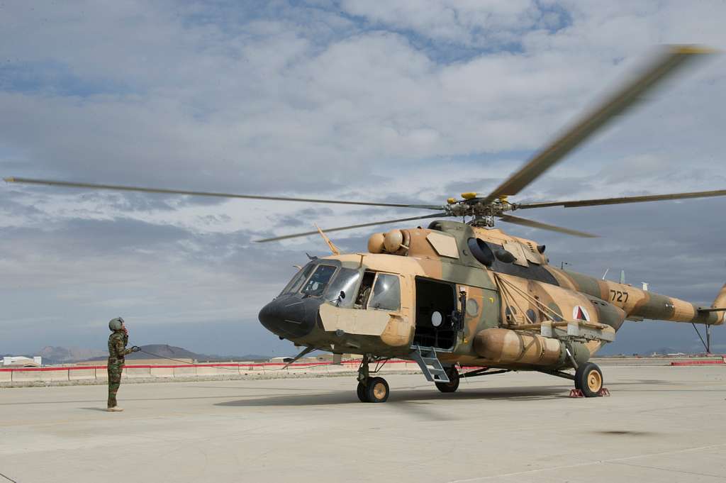 An Afghan Air Force aerial gunner communicates with - NARA & DVIDS ...