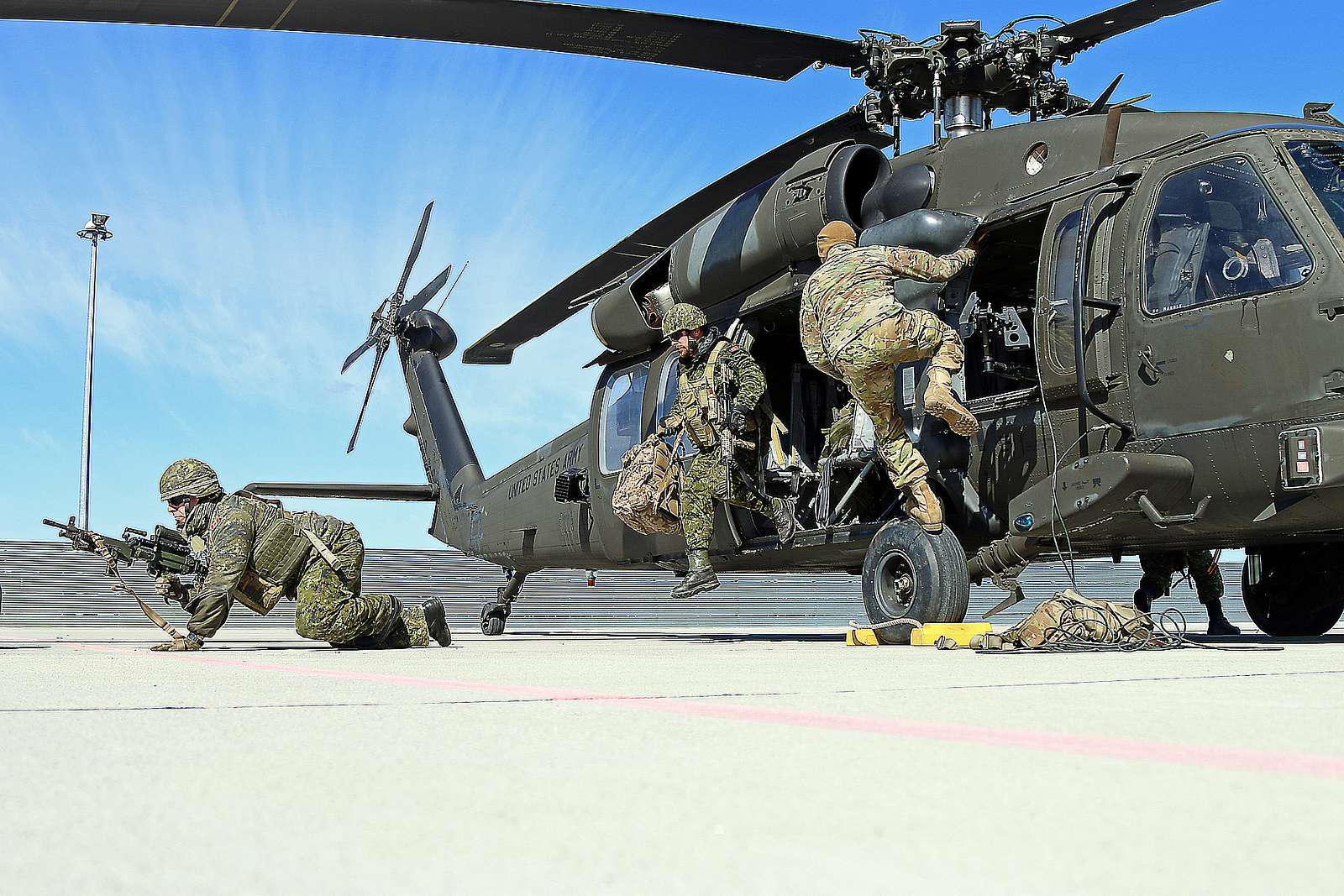 Canadian soldiers quickly exit a UH-60 Blackhawk helicopter - NARA ...