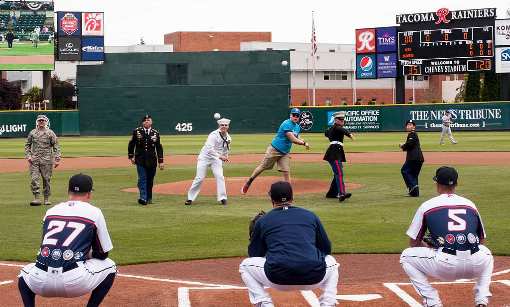 Joint Base Lewis-McChord - Tacoma Rainiers' mascot Rhubarb runs along the  third base line at Cheney Stadium with the American flag moments before the  singing of the National Anthem. DoD photo by