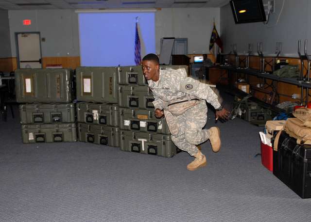 FORT FISHER, N.C. – In an assimilated field combat lifesaver course, Spc.  Alejandro Benavides (right), of the 130th Maneuver Enhancement Brigade,  rolls a casualty onto a stretcher during his National Guard annual