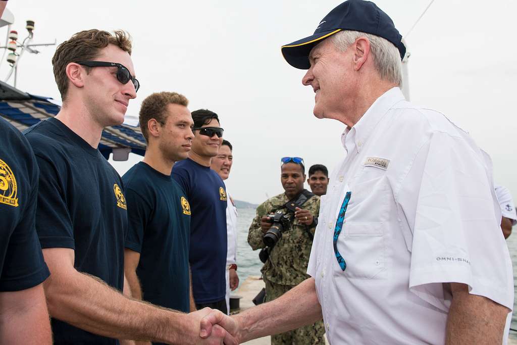 Navy Secretary Ray Mabus shakes the hands of the female service