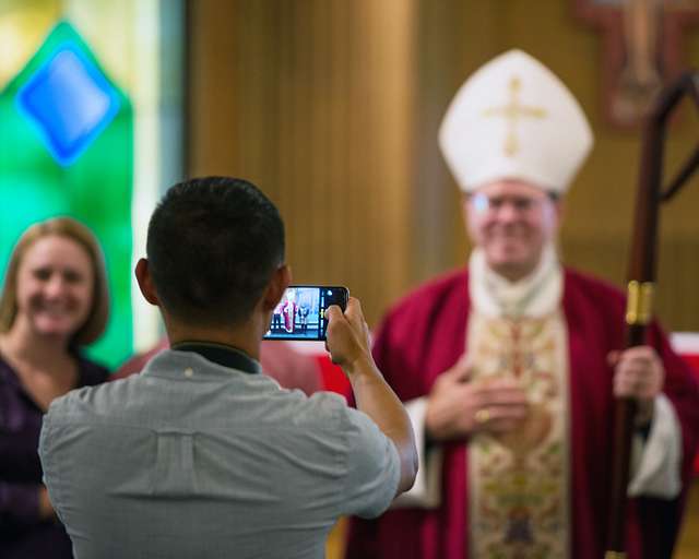 A Family Member Takes A Photo Of Bishop Neal Buckon - NARA & DVIDS ...