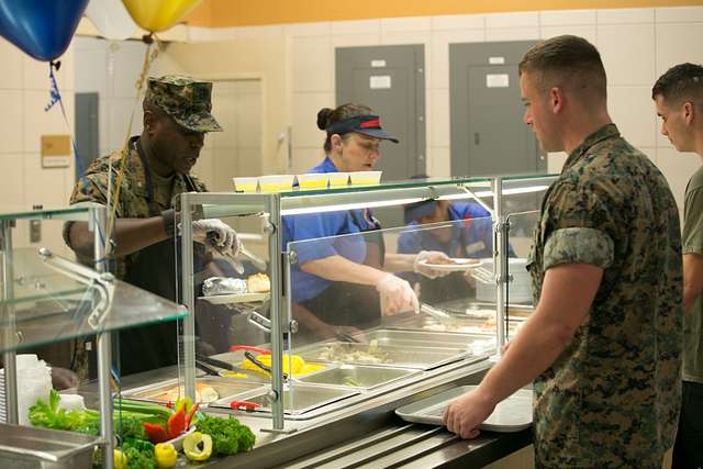 Chow hall employees and a Marine officer serves food - PICRYL - Public ...