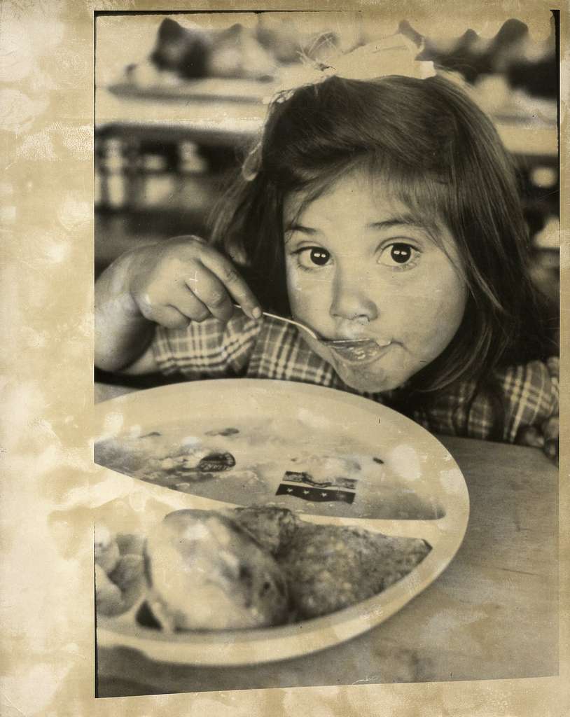 LITTLE GIRL SITTING AT TABLE EATING FOOD OFF HER PLATE. - PICRYL - Public  Domain Media Search Engine Public Domain Image