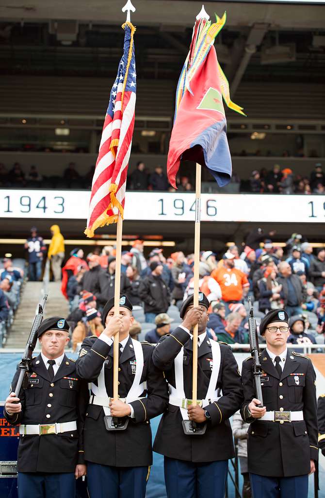 Service members take photos with Staley Da Bear, the Chicago Bears mascot  during the Chicago Bears Salute to Service game Nov. 27 at Soldier Field,  in Chicago. Nearly 100 personnel from all services participated in the pre- game and halftime show