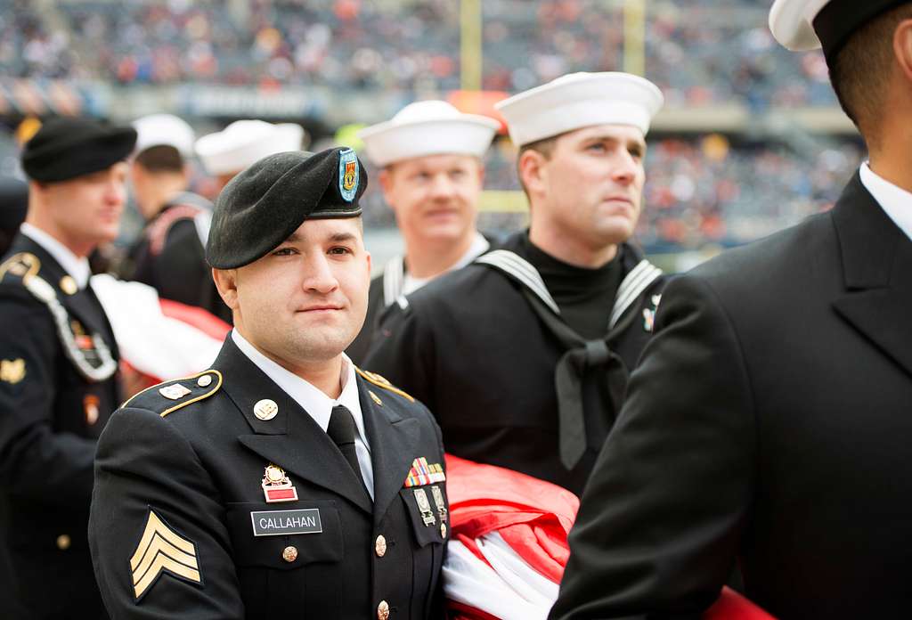 Service members take photos with Staley Da Bear, the Chicago Bears mascot  during the Chicago Bears Salute to Service game Nov. 27 at Soldier Field,  in Chicago. Nearly 100 personnel from all