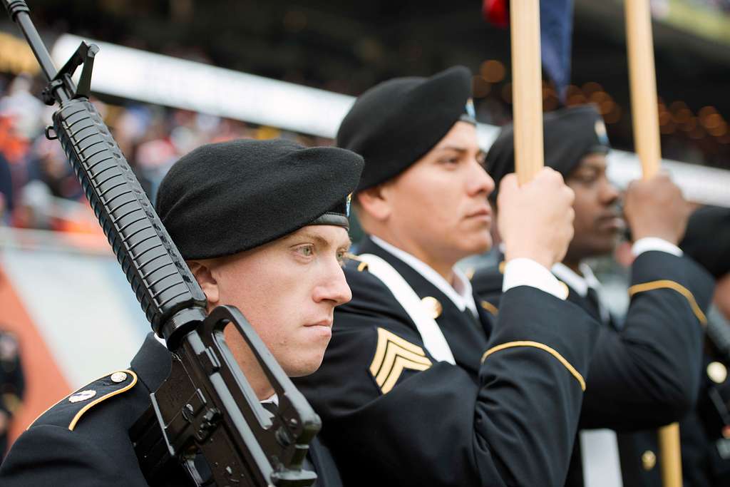 Service members take photos with Staley Da Bear, the Chicago Bears mascot  during the Chicago Bears Salute to Service game Nov. 27 at Soldier Field,  in Chicago. Nearly 100 personnel from all services participated in the  pre-game and halftime show