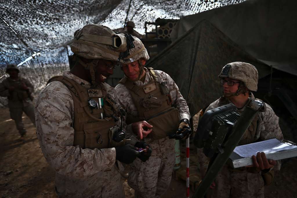 U.S. Army Spc. Bryan Hergesell, left, talks with Sgt. - PICRYL