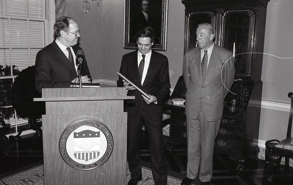 THREE MEN AT THE PODIUM WITH ONE MAN HOLDING HIS AWARD. - NARA & DVIDS ...