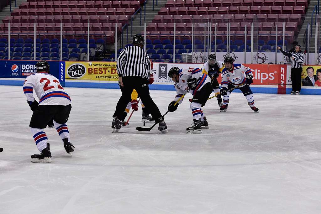 Members of the Navy, Marine Corps, and Coast Guard hockey team, in blue,  and the Air Force and Army team participate in the Wounded Warriors Charity  Hockey game. - PICRYL - Public