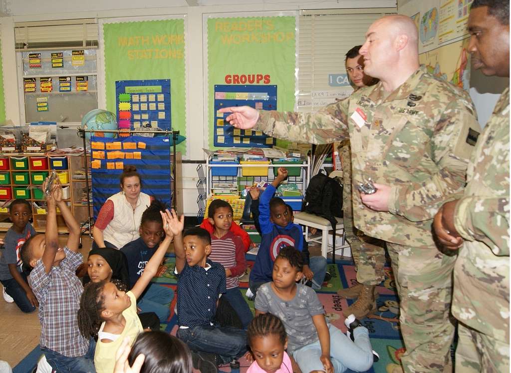 Maj. Jonwayne Lindsey (center) tosses a pencil to a - NARA & DVIDS ...