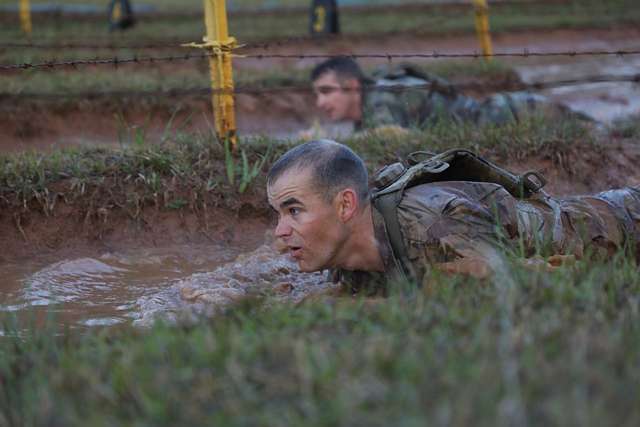 A U.S. Army Ranger low crawls under barbed wire at - NARA & DVIDS ...