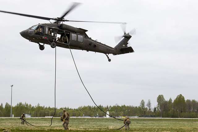 Holding the static line in a “reverse bite,” paratroopers assigned