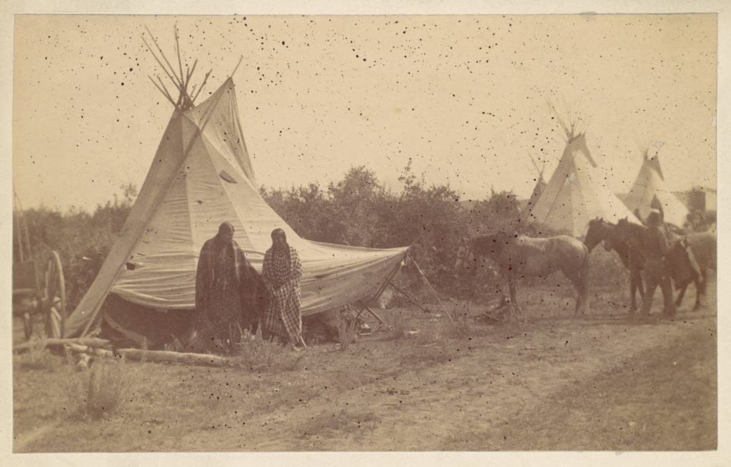 Native American Women and Horses by Teepee in Camp PICRYL