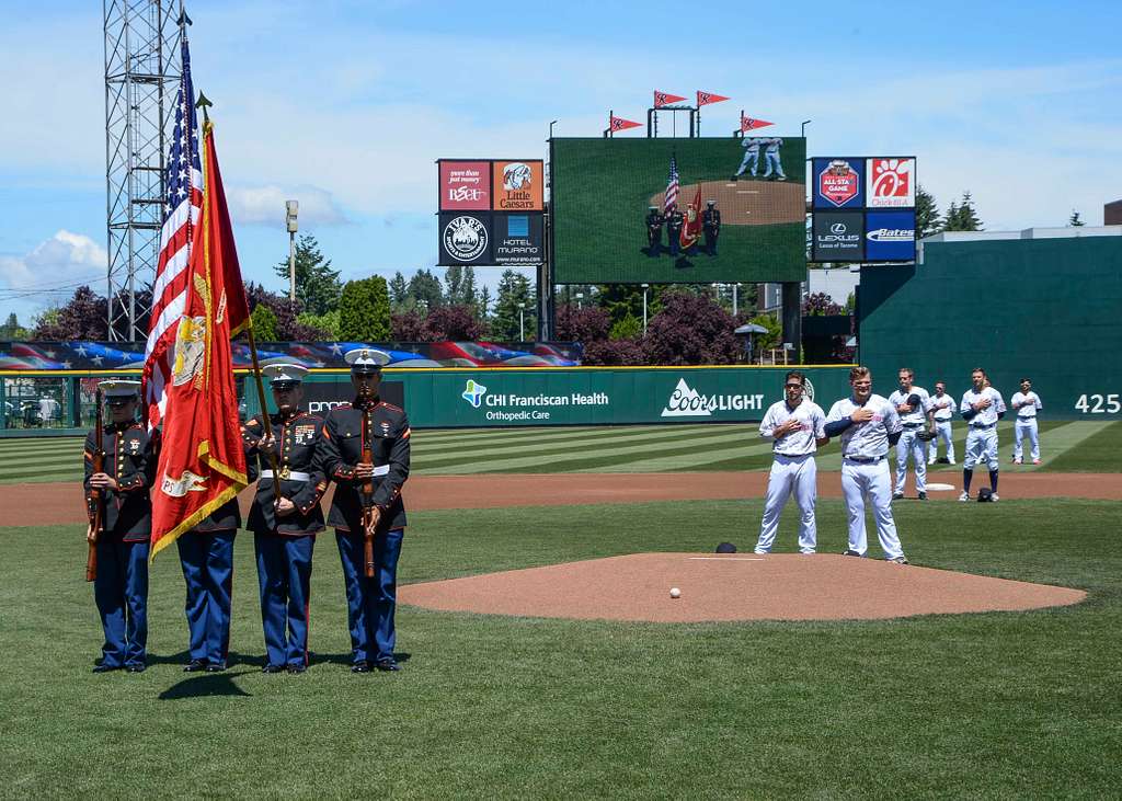 Joint Base Lewis-McChord - Tacoma Rainiers' mascot Rhubarb runs along the  third base line at Cheney Stadium with the American flag moments before the  singing of the National Anthem. DoD photo by