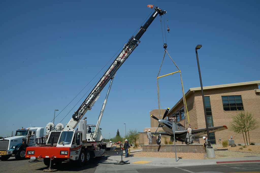 A crane moves the static P-51 Mustang into place onto - PICRYL Public ...