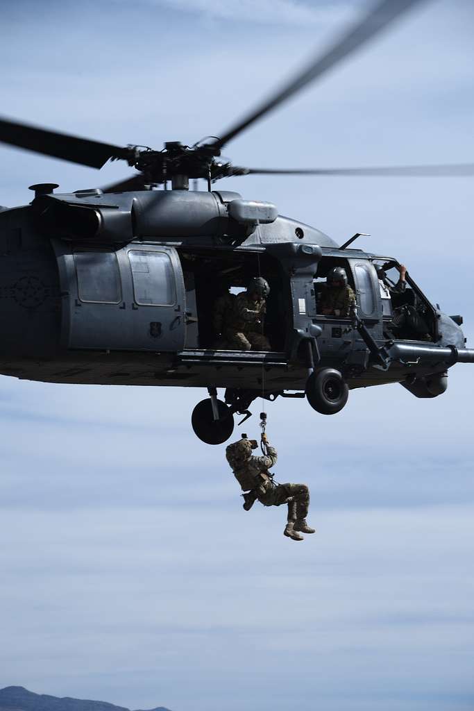 A U.S. Air Force pararescueman is hoisted into an HH-60 - NARA & DVIDS ...