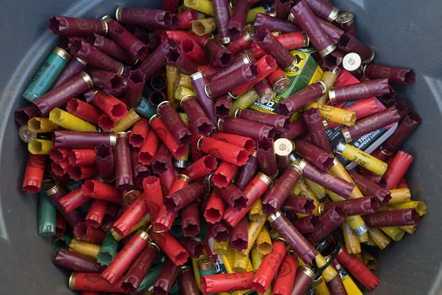 Expended shotgun shells are seen in a garbage can on - NARA & DVIDS ...