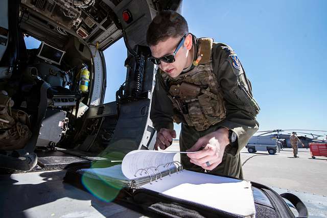 A pilot from the 41st Rescue Squadron (RQS) reads a - NARA & DVIDS ...