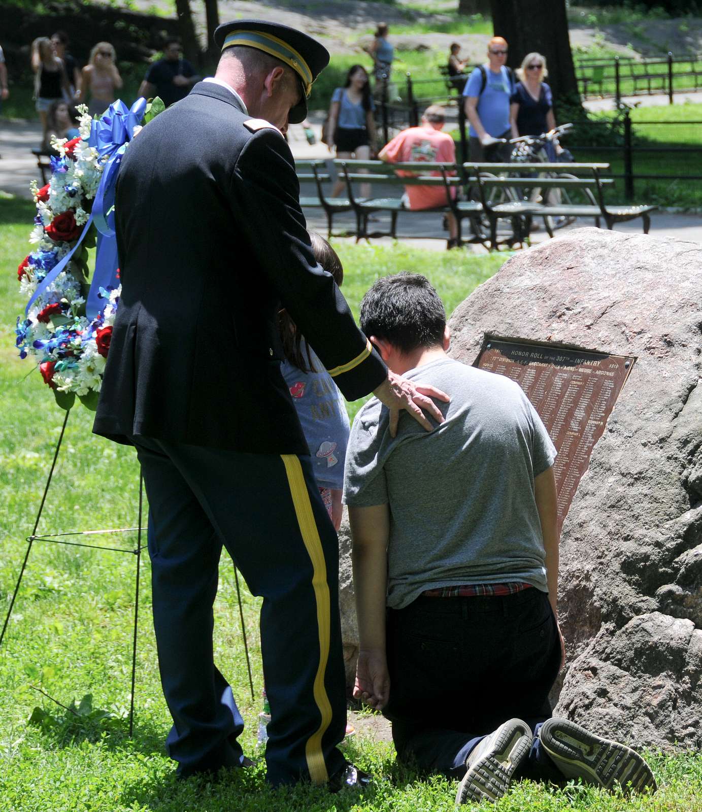 A Soldier and children visit the memorial plaque following - NARA ...