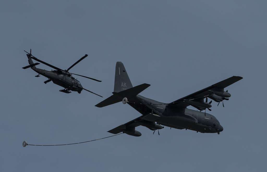 An HC-130J Super Hercules and an HH-60G Pave Hawk fly - NARA & DVIDS ...