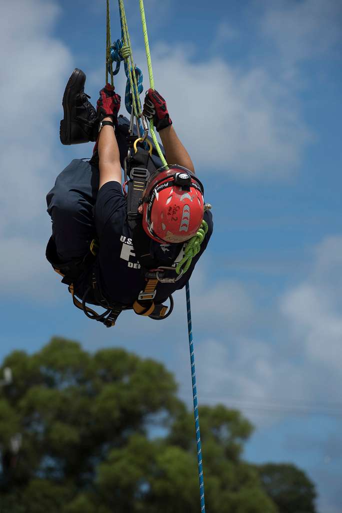 A firefighter trainee adjusts his footing during rappelling - NARA ...