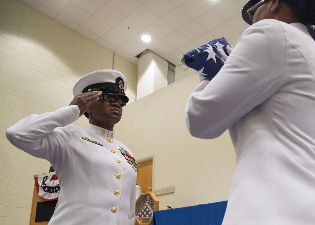 Offensive Tackle for the National Football League (NFL) San Diego Chargers,  Leander Jordan (75), signs an autograph for Aviation Electrician's Mate 3rd  Class Jerimy Holt during a visit aboard USS Ronald Reagan (