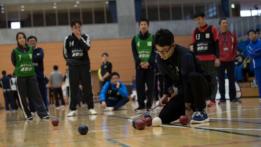 A Paralympics judge measures a hacky sack ball during PICRYL