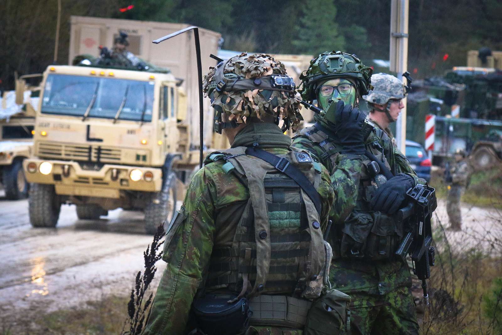 A Lithuanian soldier communicates on a radio during - NARA & DVIDS ...