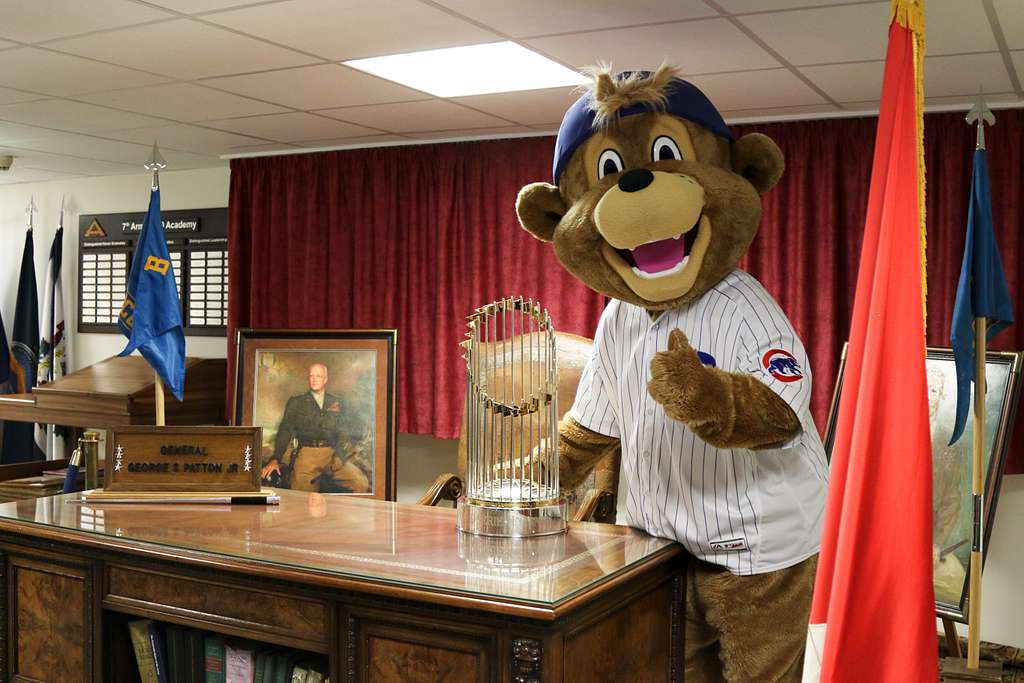 Clark, the Chicago Cubs mascot, signs a hat for a fan at the USO at USAG  Bavaria in Grafenwoehr, Germany, Dec. 11, 2018. The USO sponsored a Chicago  Cubs mascot tour of