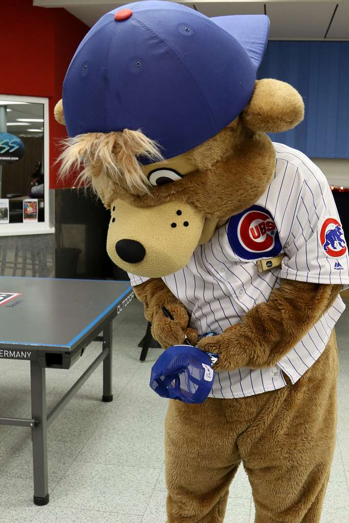 Clark, the Chicago Cubs mascot, signs a hat for a fan - NARA
