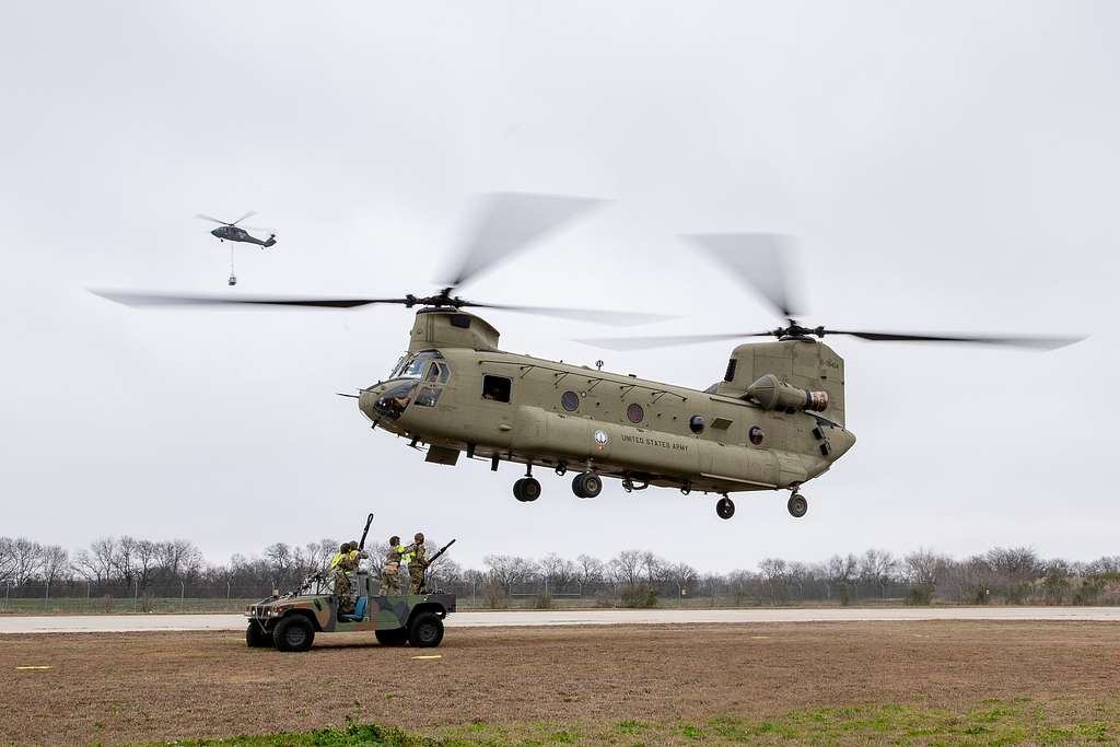 A CH-47 Chinook helicopter prepares to receive a Humvee - PICRYL ...